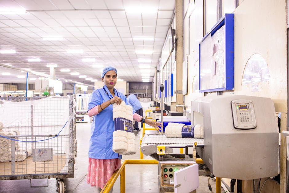 Female textile worker organizing products in a factory setting.